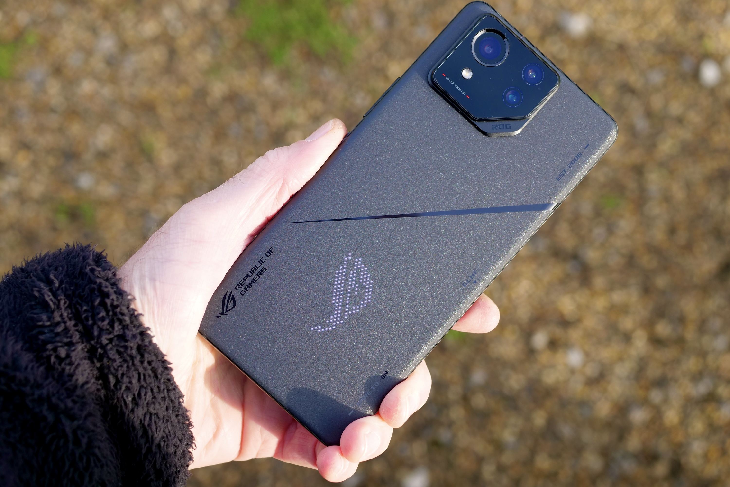 A person holding the Asus ROG Phone 8 Pro.